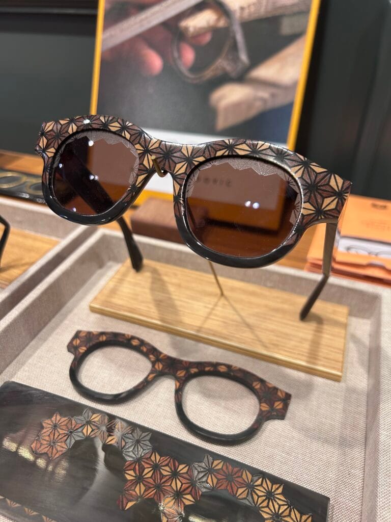 IMG_6531 2 copy | Eyestylist Sunglasses with a Brown Geometric Starburst Pattern on Display, with Matching Frame Pieces Nearby on a Fabric-covered Surface. | Eyestylist 18th May 2026