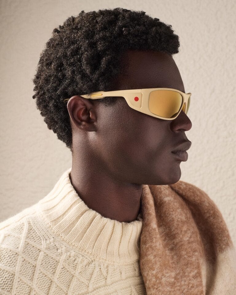 Side Profile of a Man Wearing Beige Wraparound Sunglasses, Cream Knit Sweater, and a Tan Scarf.  | Eyestylist 10th June 2026