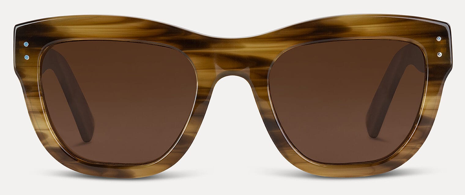 Front view of tortoiseshell sunglasses with brown lenses against a light background, cropped at the bottom edge of the frame.