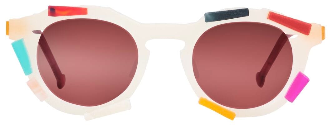 White round sunglasses with gradient lenses and multicolored rectangular tabs attached to the frame as a playful design accessory