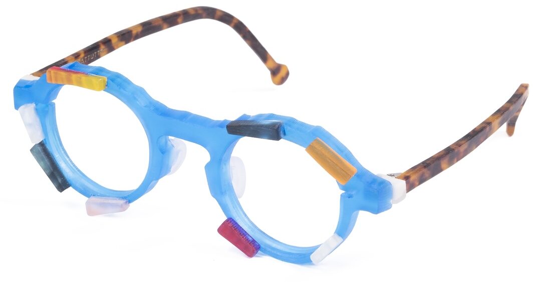 Colorful blue novelty glasses with orange tortoise-shell arms and assorted colored tabs attached to the frames as decorative accents.