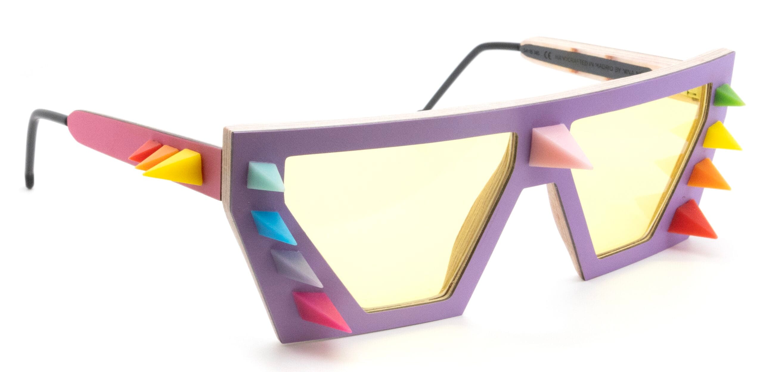 Purple oversized sunglasses with multicolored spike accents along the frame, view from side. (Informative product shot)