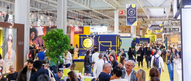 54823233220_d0575819bb_k | Eyestylist Bustling Trade Show Hall with Colorful Booths, Signs, and a Crowd of Attendees Exploring Exhibitors. | Eyestylist 8th September 2026