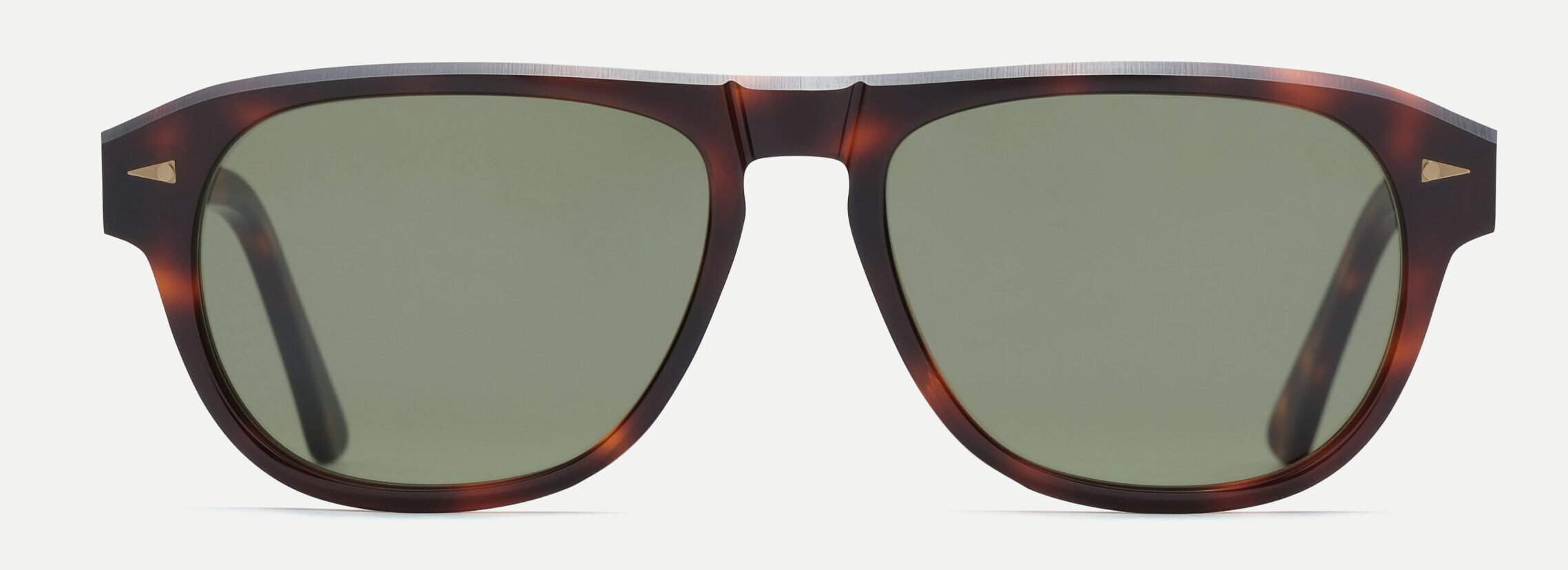 Close-up of brown tortoiseshell sunglasses with dark lenses, cropped at the bottom edge of the frame