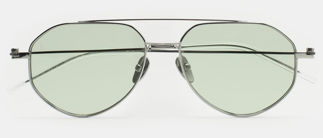 Pair of aviator sunglasses with pale green lenses and a metal frame on a white background.