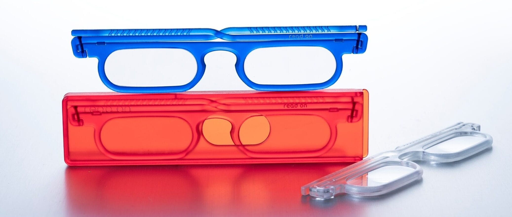 read on bold_1 copy | Eyestylist Stack of Red and Blue Plastic Cases with Circular Cutouts, Arranged in a Vertical Stack on a White Surface. | Eyestylist 8th September 2026